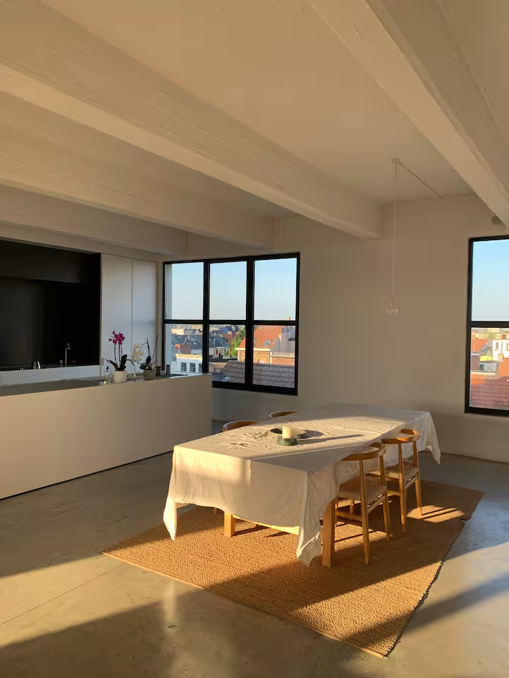 Dining table prepared in the Antwerp loft for a shared meal